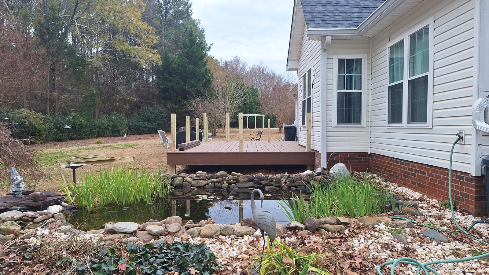 Deck overlooking a landscaped garden pond edged with rock