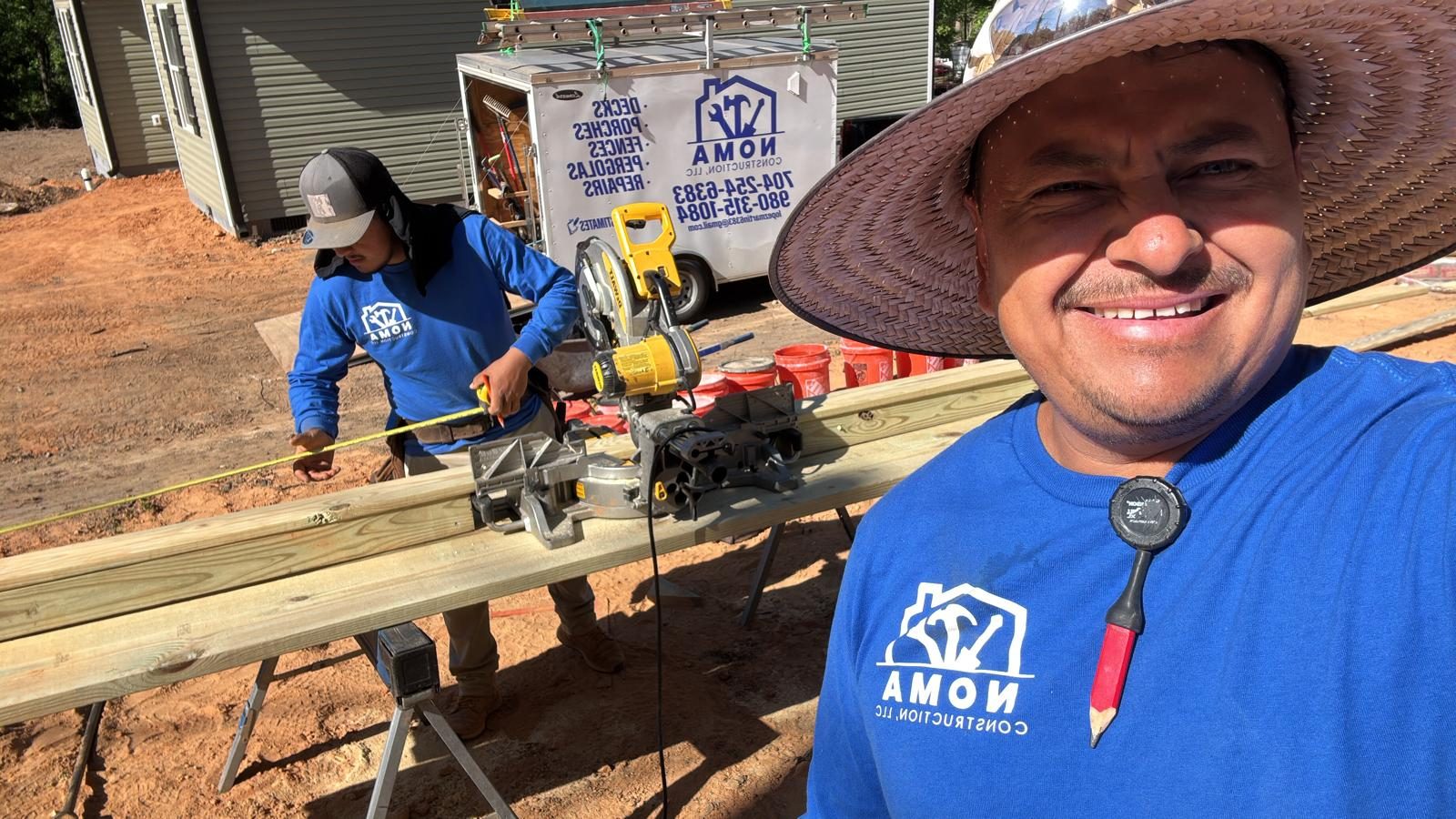 Two members of the Noma Construction crew cutting timber on site