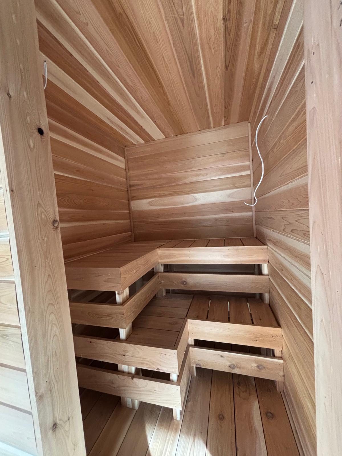 Interior of a custom cedar sauna with tiered benches